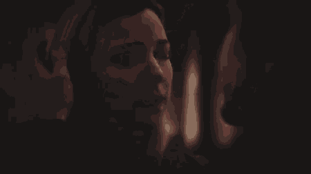 a close up of a woman 's face with a blurred background
