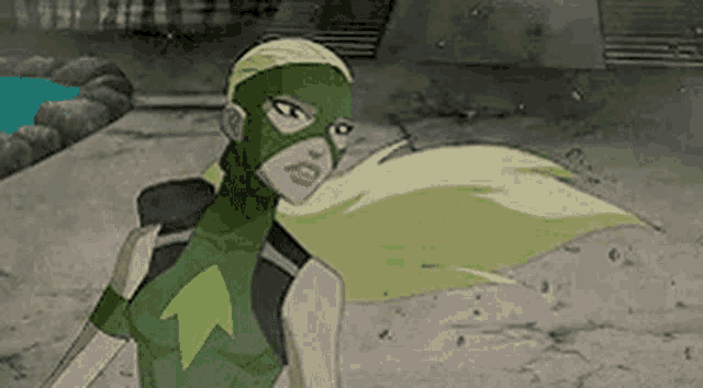 a cartoon character wearing a green mask and cape is standing on a sidewalk .