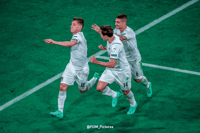 a group of soccer players on a field with a sign in the background that says " together "