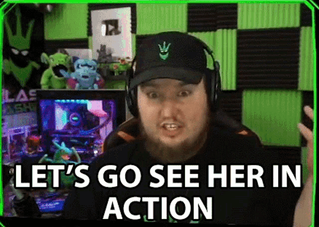 a man with a beard is wearing headphones and a hat and says `` let 's go see her in action ''