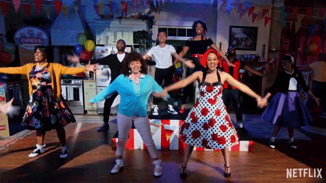 a group of people are dancing in front of a sign that says carnival on it