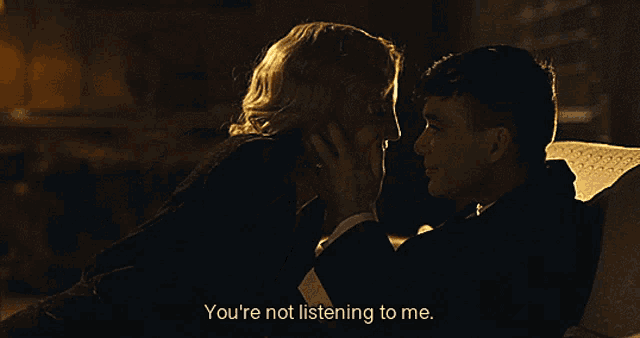 a man and woman are looking at each other with the words you 're not listening to me