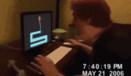 a man is typing on a computer with a picture of a boy on the screen and the date may 21 2006
