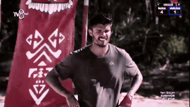 a man is smiling in front of a red banner that says tv8 hd