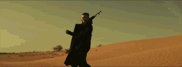 a man with a tattoo on his neck is holding a rifle over his shoulder