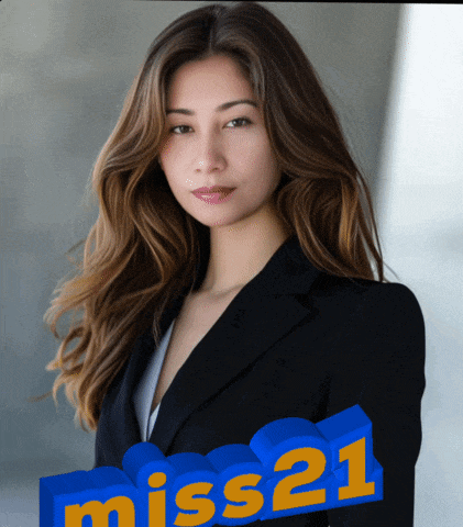 a woman in a black suit stands in front of a miss21 sign
