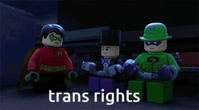 three lego figures are standing next to each other and the words trans rights are visible