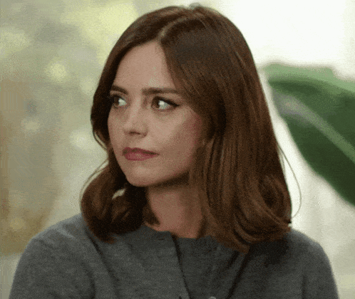 a close up of a woman 's face with brown hair