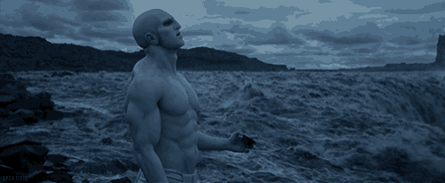 a shirtless man stands in the water with the word sealife on the bottom