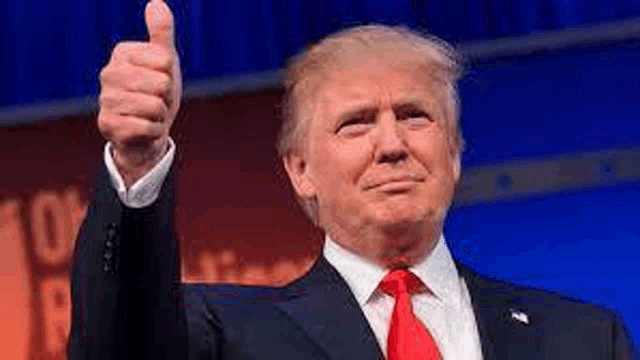president donald trump is giving a thumbs up sign while wearing a suit and tie .