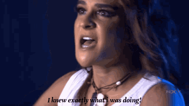 a woman says " i knew exactly what i was doing " in front of a blue background