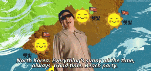 a man is standing in front of a map that says north korea everything 's sunny all the time