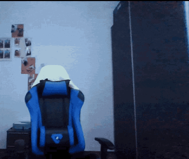 a blue and black chair with a blue heart on the back sits in a dark room