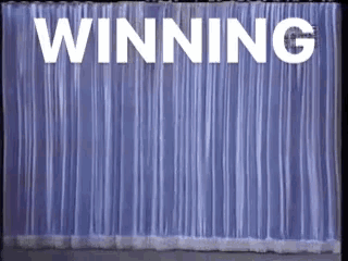 the word winning is on a blue curtain