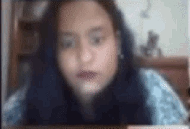a blurry picture of a woman 's face is being displayed on a screen .