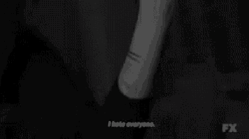 a black and white photo of a person 's wrist with fx written on the bottom right corner