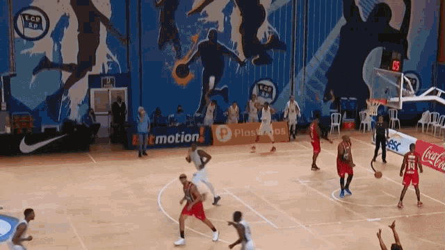 a basketball game is being played on a court with an advertisement for coca cola