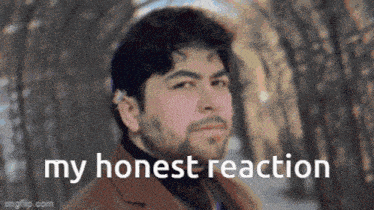 a man with a beard is standing in front of trees with the words `` my honest reaction '' written below him .