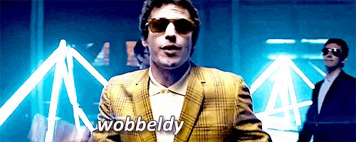 a man in a suit and sunglasses says wobbedly
