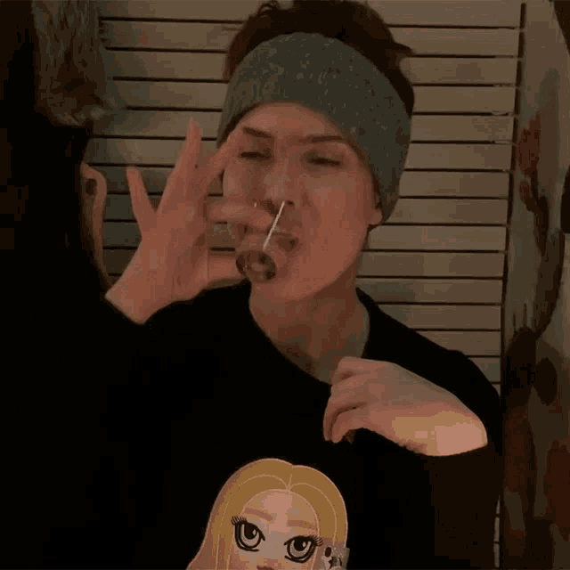 a woman wearing a black sweater with a cartoon girl on it