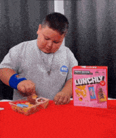 a boy is eating a box of lunchify cereal