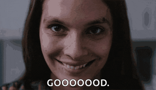 a close up of a woman 's face with the words goooood written below it