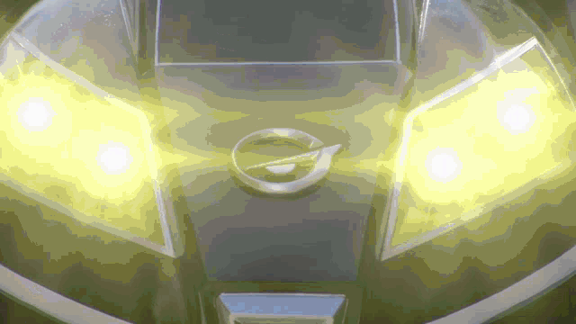 a close up of a car 's headlights with a yellow glow