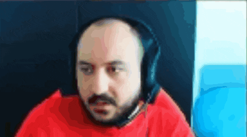 a bald man with a beard is wearing headphones