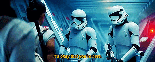 a group of stormtroopers are standing next to each other and one of them says it 's okay that you 're here