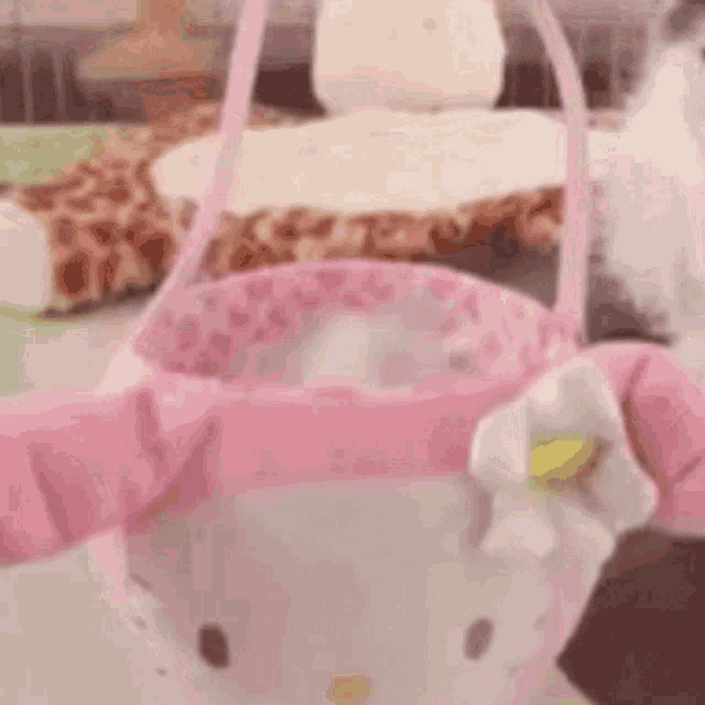 a pink hello kitty purse is sitting on a table .