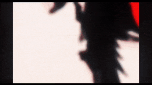 a blurry picture of a person 's shadow on a white background with a red border .