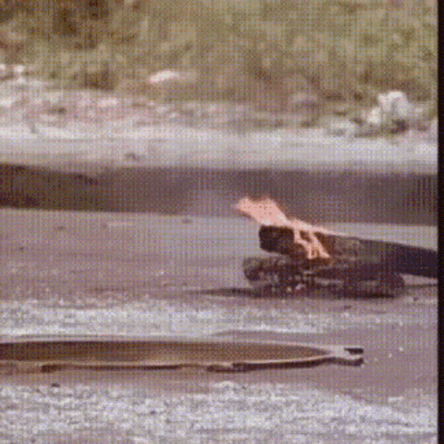 a manhole cover is laying on the ground next to a skateboard