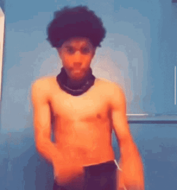 a man without a shirt is dancing in a bathroom .