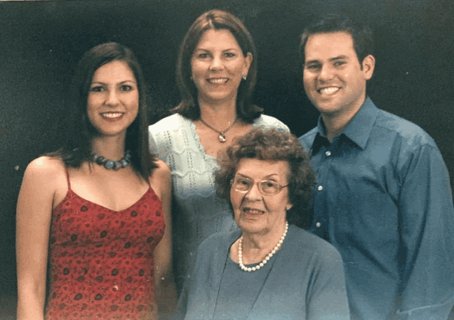 a group of people posing for a picture including an elderly woman