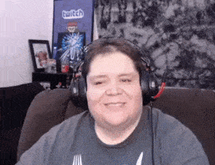 a man wearing headphones is sitting on a couch .