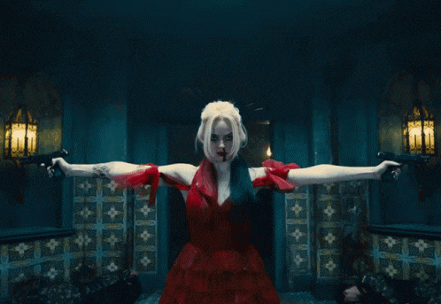 a woman in a harley quinn costume holding two guns