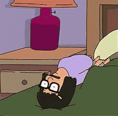 bob from bob 's burgers is laying on his stomach in bed