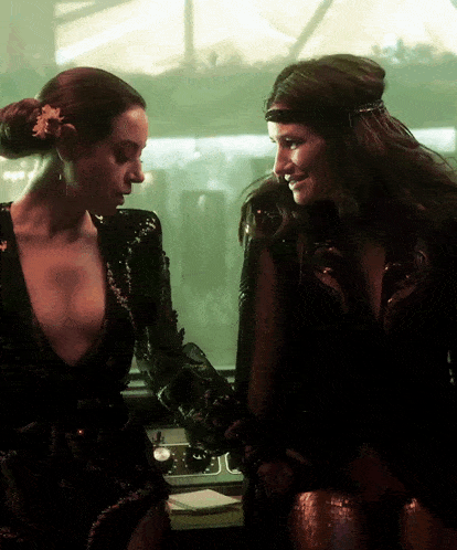 two women standing next to each other with one wearing a headband