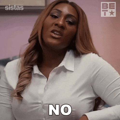 a woman in a white shirt is holding her breast and says no