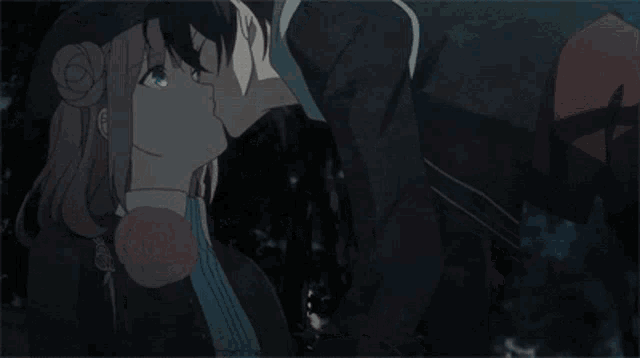 a boy and a girl are looking at each other in a dark forest