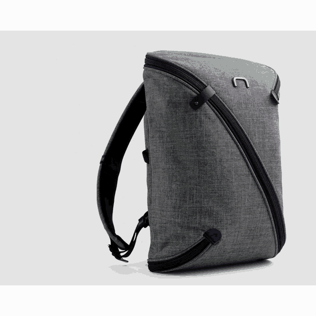 a gray backpack with a black zipper and the letter u on it