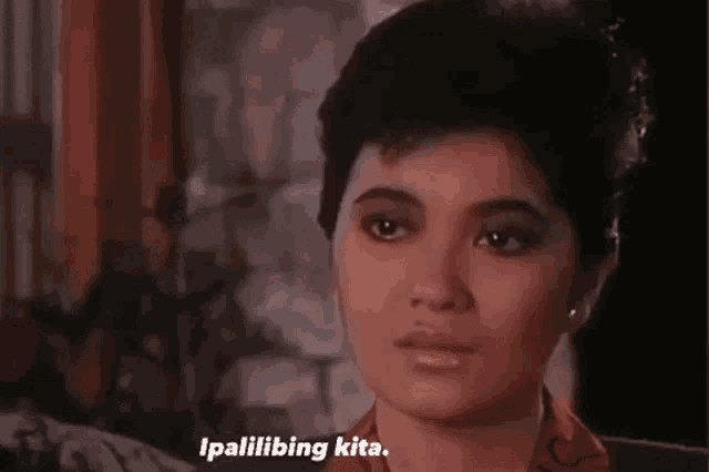 a close up of a woman 's face with the words `` ipalilibing kita '' above her .