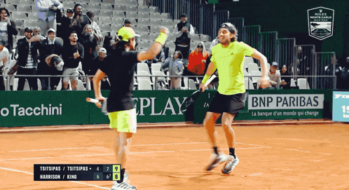 two tennis players on a court with an advertisement for bnp paribas behind them