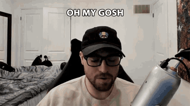 a man wearing glasses and a black hat says oh my gosh