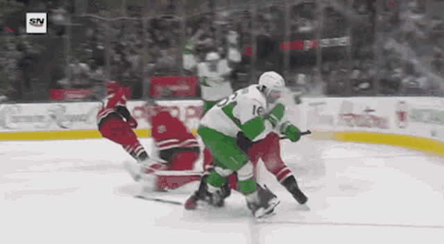 a hockey game is being played on a ice rink with advertisements for tim hortons and coca cola