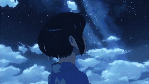 a girl in a blue shirt is looking up at the night sky