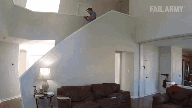 a man stands on a staircase in a living room with failarmy written on the bottom right