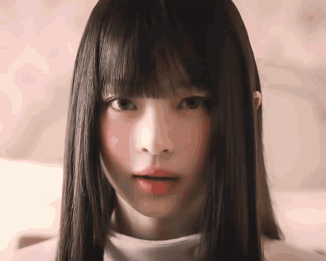 a close up of a woman 's face with long hair and red lips