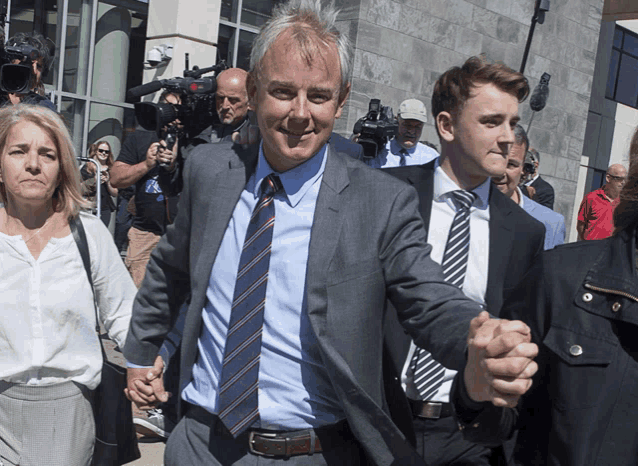a man in a suit and tie is holding hands with a woman