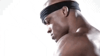 a shirtless man with a headband on his head